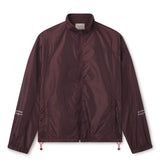 Lightweight comfort, fast-drying performance, and minimalist design. Image of male model wearing the WHITESPACE Windbreaker Jacket fudge color