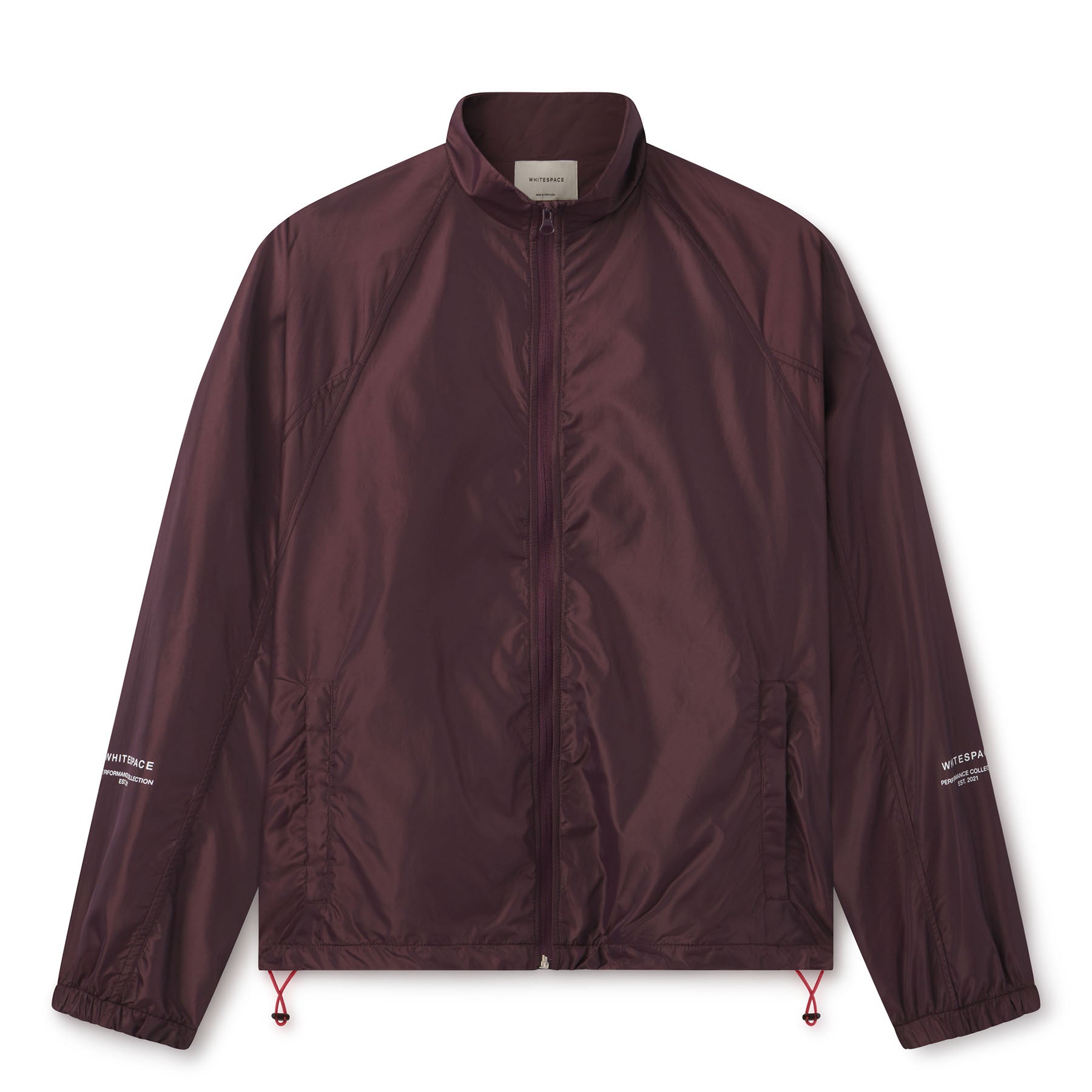 Lightweight comfort, fast-drying performance, and minimalist design. Image of male model wearing the WHITESPACE Windbreaker Jacket fudge color