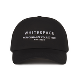 Black cap with 'WHITESPACE PERFORMANCE COLLECTION EST. 2021' text on a white background