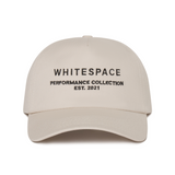 Beige cap with 'WHITESPACE PERFORMANCE COLLECTION EST. 2021' text on a white background