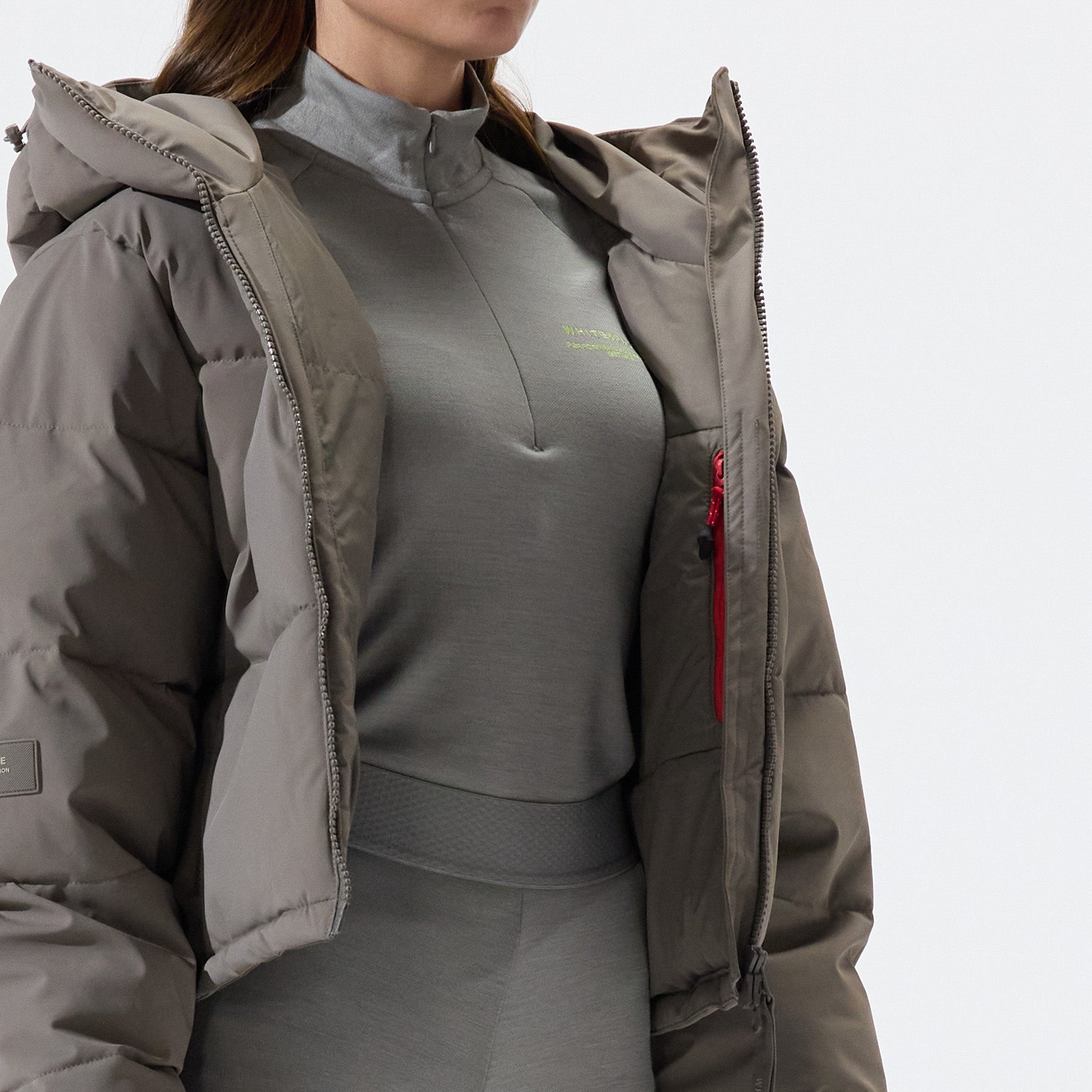 Model wearing Cropped Puffer Jacket in Falcon colorway over coordinating beige baselayers, on a white background.