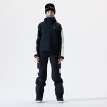 Model wearing a black snowsuit with white accents on a white background