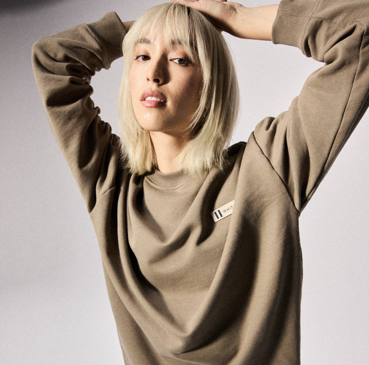 Female model wearing the WHITESPACE Fleece Crewneck - Falcon.