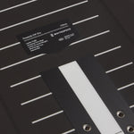 Black Freestyle SW Pro snowboard deck with a label on a black background