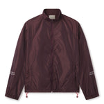 Lightweight comfort, fast-drying performance, and minimalist design.  Image of male model wearing the WHITESPACE Windbreaker Jacket fudge color