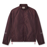 Lightweight comfort, fast-drying performance, and minimalist design.  Image of male model wearing the WHITESPACE Windbreaker Jacket fudge color