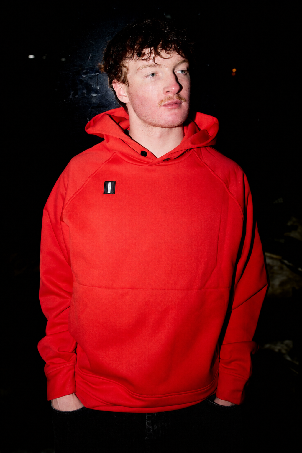 Male model wearing the WHITESPACE Power Fleece Hoodie in Aura Orange.