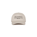 Beige five panel cap with 'WHITESPACE PERFORMANCE COLLECTION EST. 2021' text on a white background