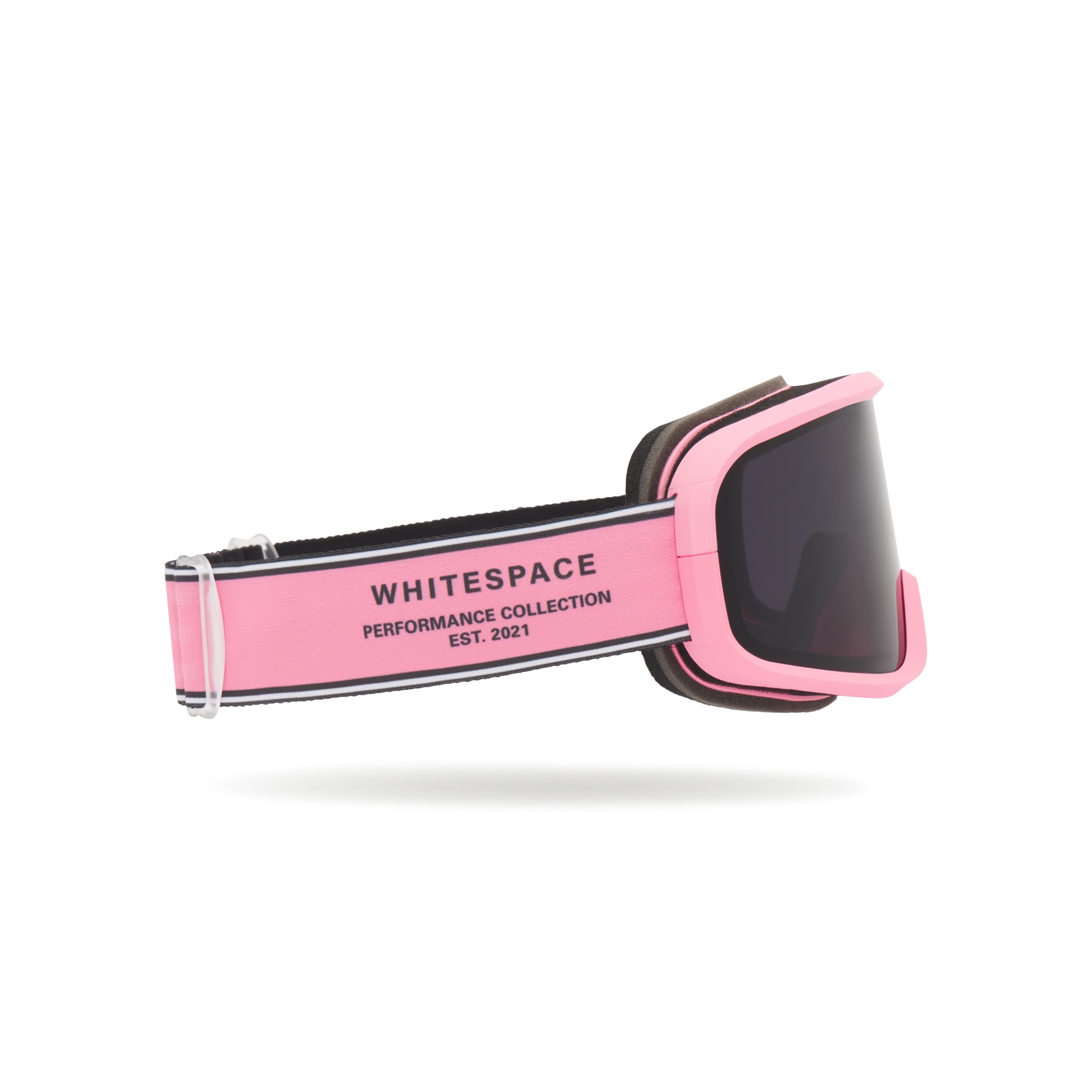 Dark tinted goggles in Pink Icing colorway with 'Whitespace' branding from a side view on a white background.