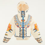 Flat lay photo of Farm Rio Lucy Floral Puffer Jacket, a cream colored jacket with blue and yellow floral designs, on a white background.