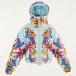 Flat lay photo of Farm Rio Macaw puffer jacket, a light blue jacket with macaw graphic design, on a white background.