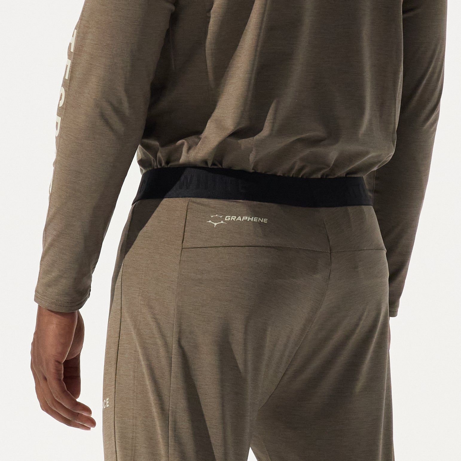 Model from the back, wearing graphine crewneck and graphine basepant in falcon colorway on a white background.