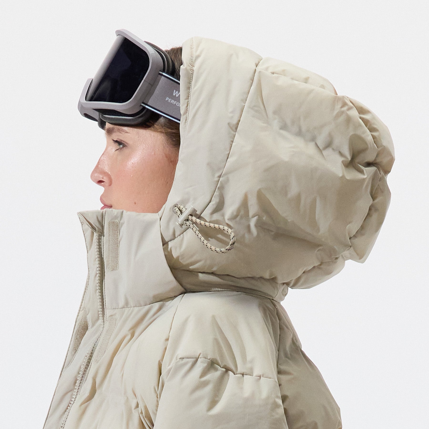 Side view of model wearing Insulated Parka Jacket in Plaza Taupe, on a white background