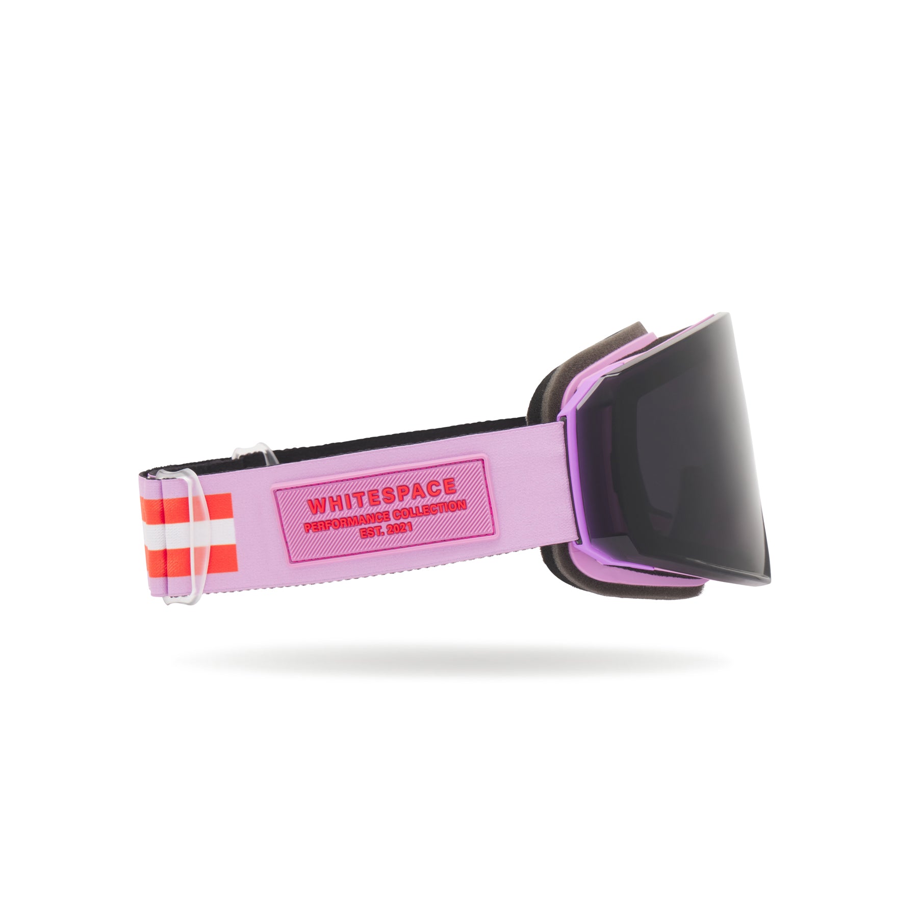 Lilac goggles with a black lens on a white background, brand logo shows on strap.