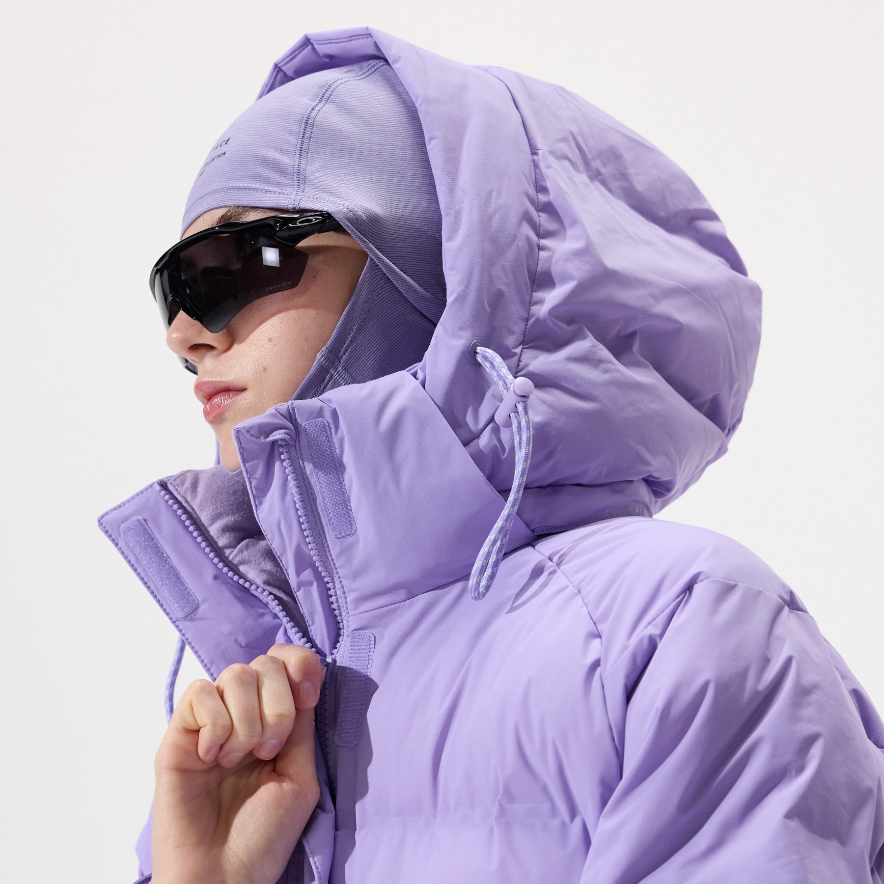 Model wearing a Insulated Parka Jacket in Sand Verbena and matching balaclava with 'Whitespace' branding on a white background.