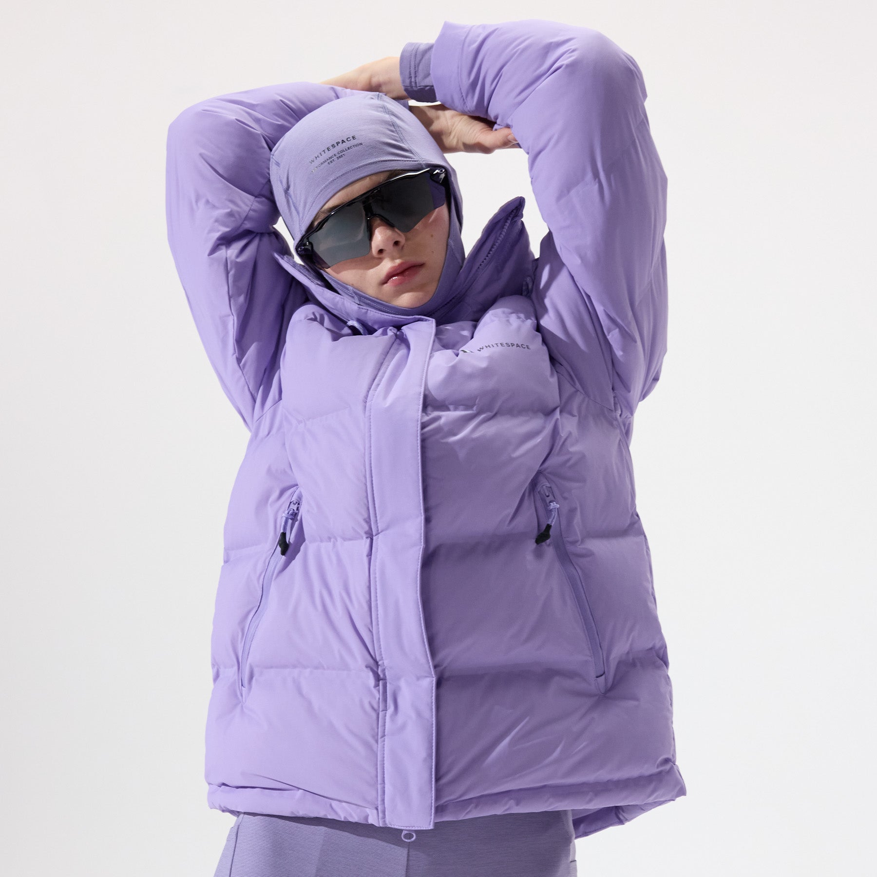 Model wearing a Insulated Parka Jacket in Sand Verbena and matching balaclava with 'Whitespace' branding on a white background.