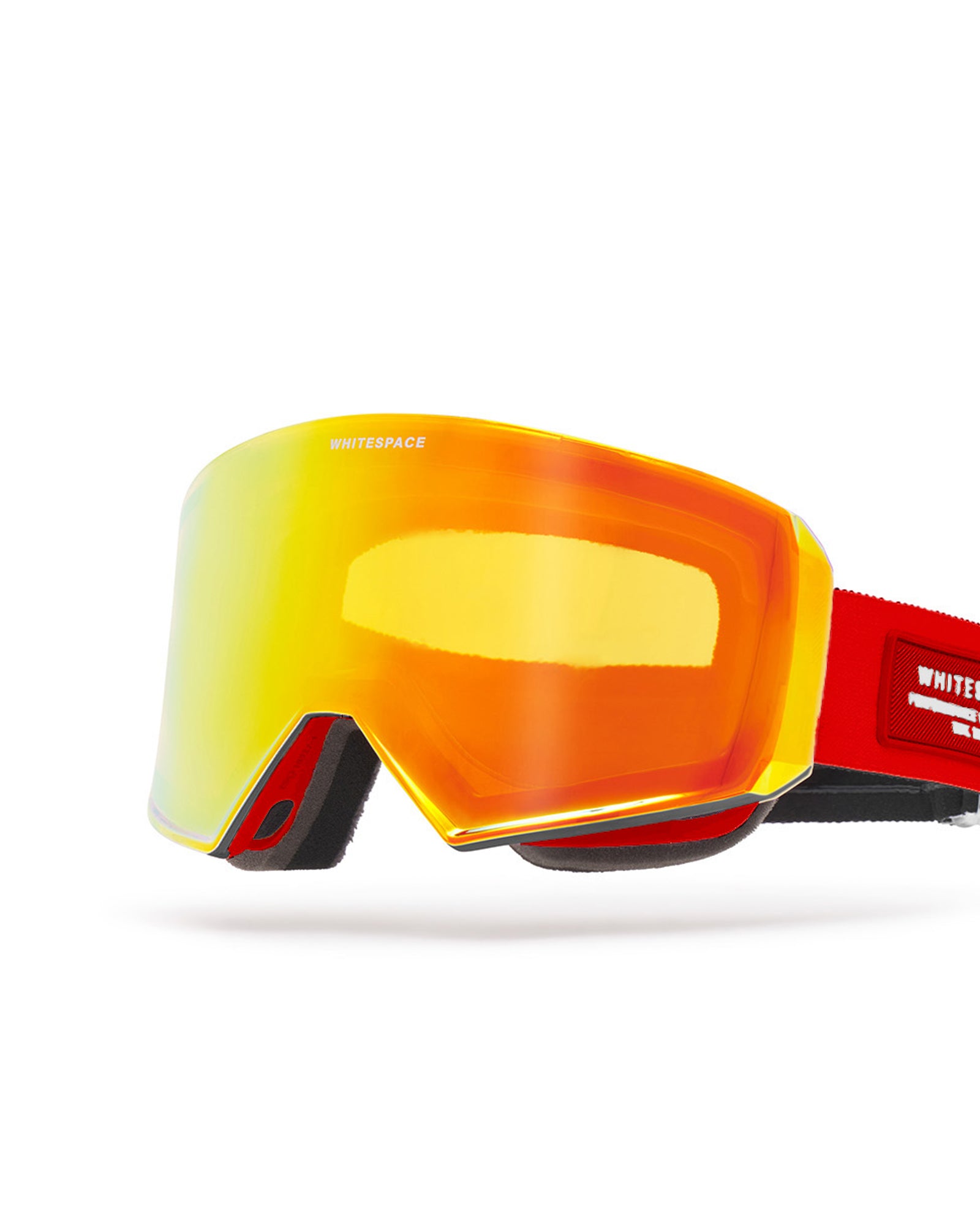 Close-up of a red and black ski outfit featuring WHITSPACE MD Icon Goggles with a reflective black lens. 