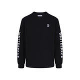 Black  long-sleeved tee shirt with WHITESPACE logo on down the sleeves, against a white background