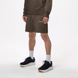 Model wearing WHITESPACE quarter zip sweatshirt in slate black/desert taupe and slate black fleece shorts with black shoes and white socks, shown from mid chest and down