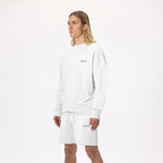 Model wearing WHITESPACE Fleece Crewneck in whisper white and whisper white fleece shorts, shown from the knees up, against a white background.
