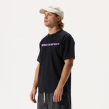 Model wearing WHITESPACE Premium Graphic short sleeved tee in black, black shorts, and a cream ball cap, on a white background.