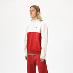 Model wearing WHITESPACE quarter zip sweatshirt in aura orange/whisper white and aura orange WHITESPACE travel pants, shown from knees up