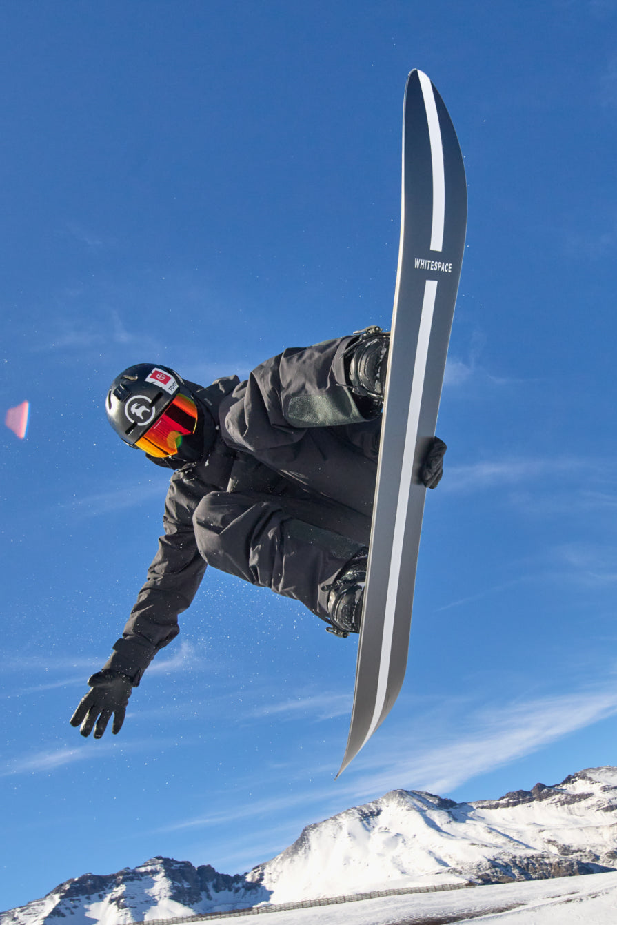 Snowboarding performing aerial ona WHITESPACE snowboard.