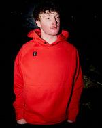 Male model wearing the WHITESPACE Power Fleece Hoodie in the color Aura Orange