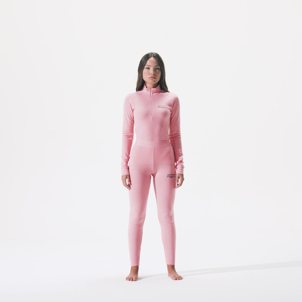 Video of model wearing women's merino baselayer kit in pink icing.
