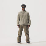 Video of model wearing Perfornance 3L Pant in Falcon color and a beige jacket and black sunglasses.