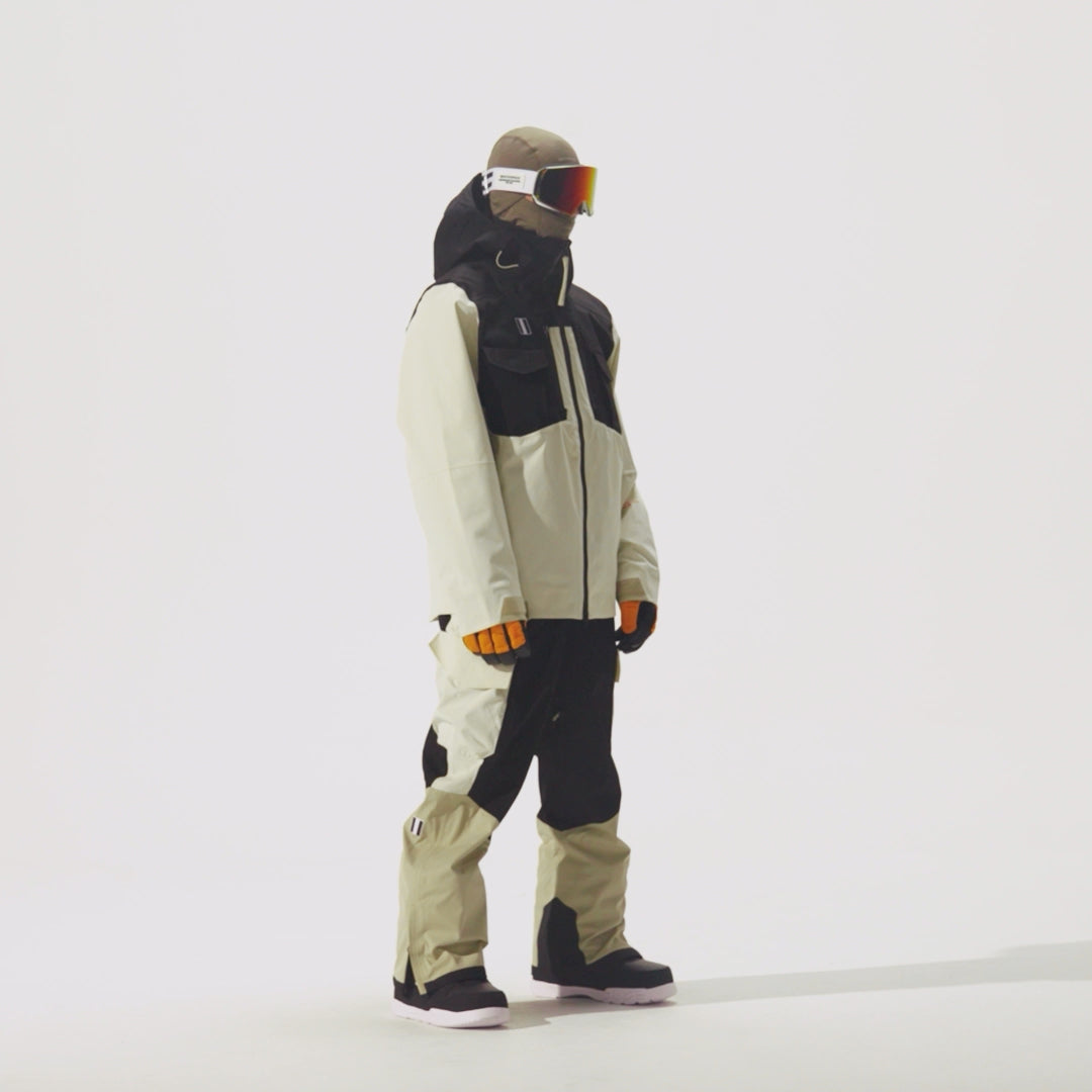 Video of model wearing 2L Insulated Cargo Jacket in Plaza Taupe/Black Onyx/Bone colorway and coordinating pants on a white background.
