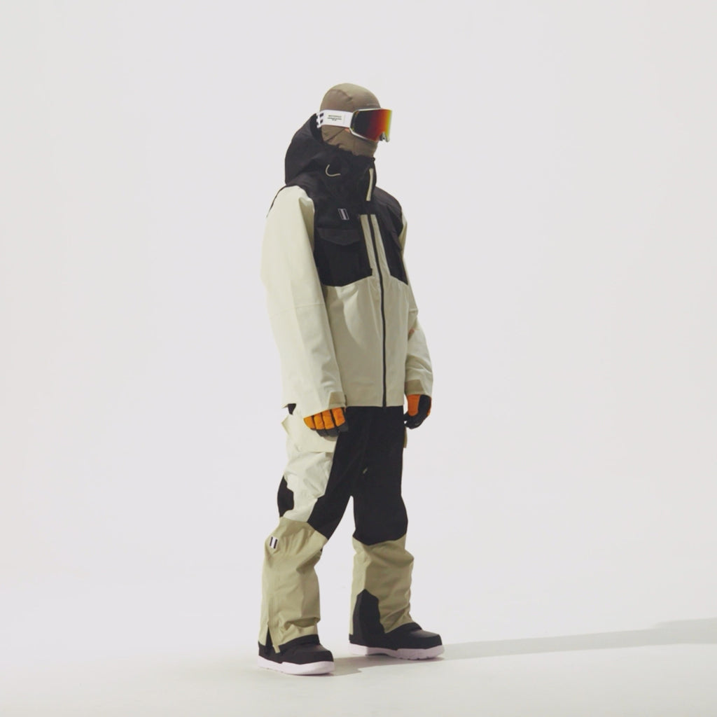 Video of model wearing 2L Insulated Cargo Jacket in Plaza Taupe/Black Onyx/Bone colorway and coordinating pants on a white background.
