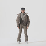 Video of model wearing Cropped Puffer Jacket in Falcon colorway with coordinating snow pants.