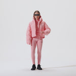 Video of model wearing Cropped Puffer Jacket in Pink Icing colorway over coordinating pink icing baselayers.