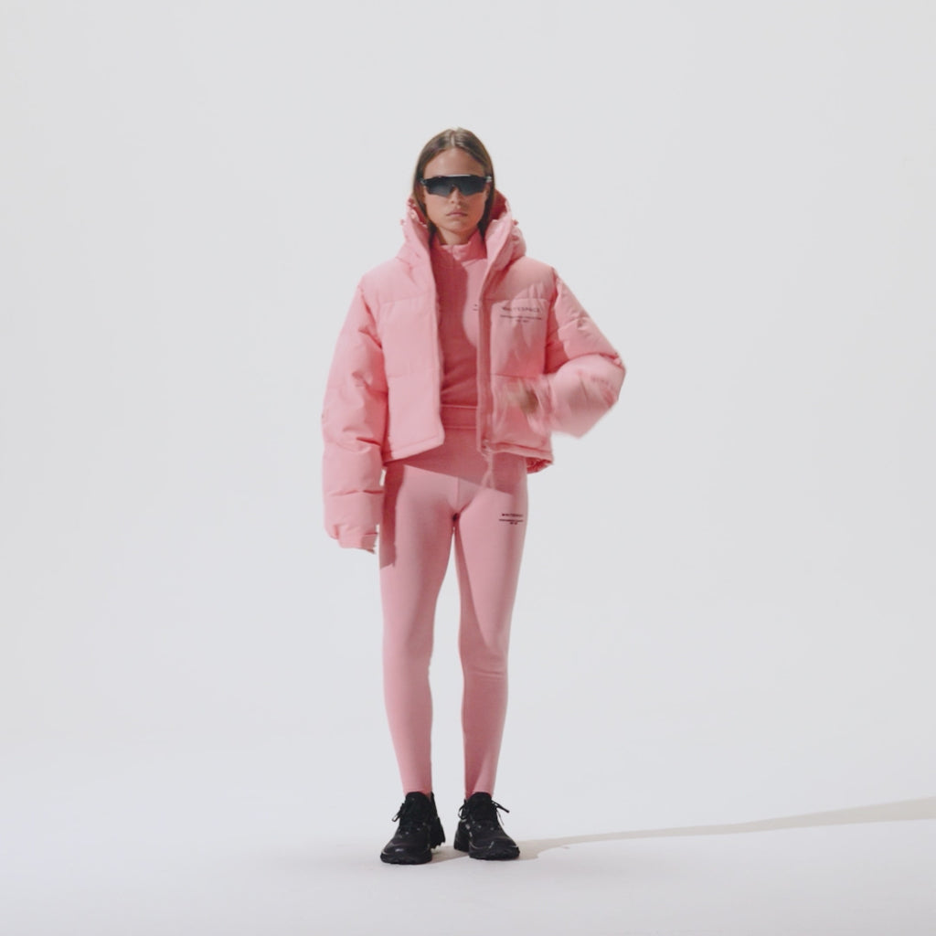 Video of model wearing Cropped Puffer Jacket in Pink Icing colorway over coordinating pink icing baselayers.